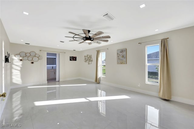 tiled empty room with ceiling fan