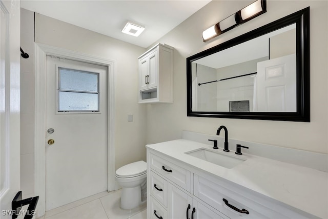 bathroom featuring vanity, tile patterned flooring, a shower, and toilet