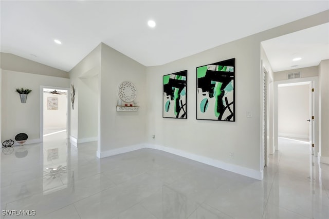 spare room featuring ceiling fan and lofted ceiling