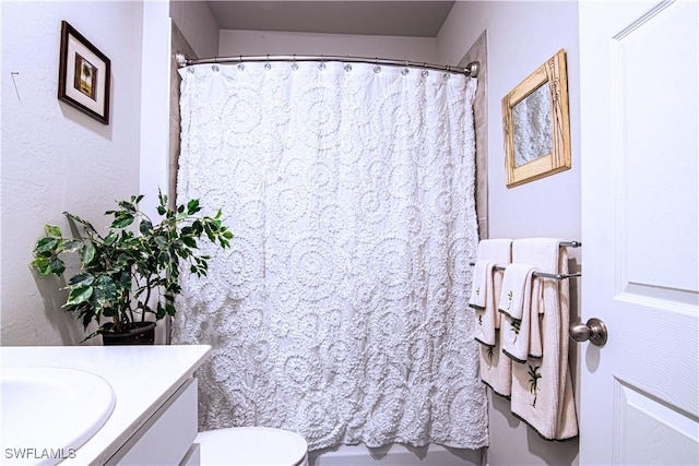 bathroom with vanity, a shower with curtain, and toilet