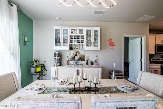 interior space with appliances with stainless steel finishes and white cabinets