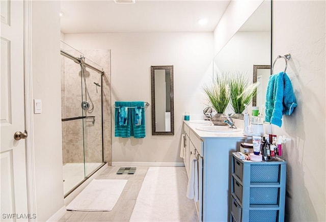 bathroom featuring walk in shower and vanity