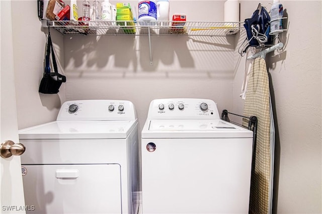 laundry room with washing machine and clothes dryer