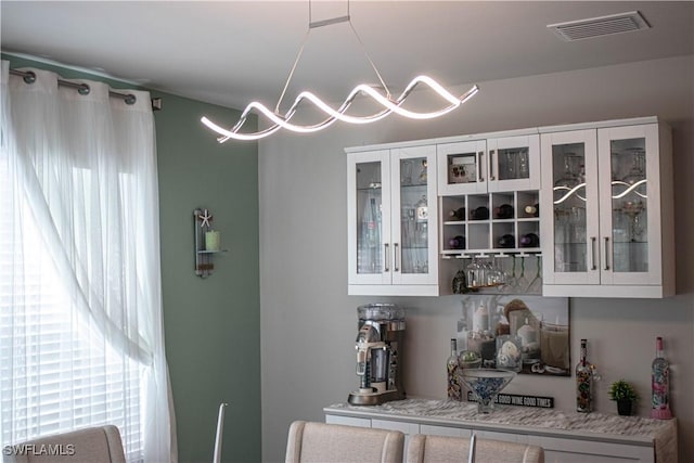 314 SW 29th St, Cape Coral, FL 33914 - bar with white cabinetry and a notable chandelier