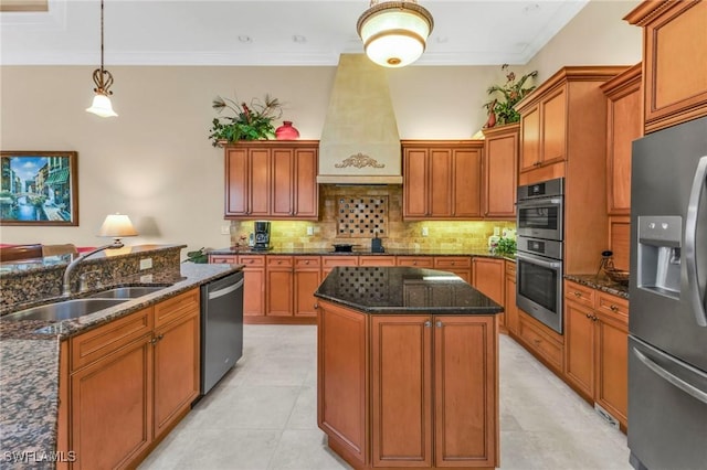 kitchen with a kitchen island, decorative light fixtures, sink, custom exhaust hood, and stainless steel appliances