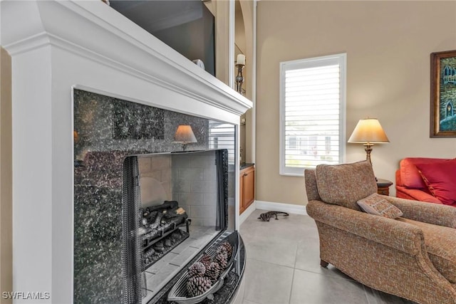 living room featuring a fireplace and light tile patterned flooring