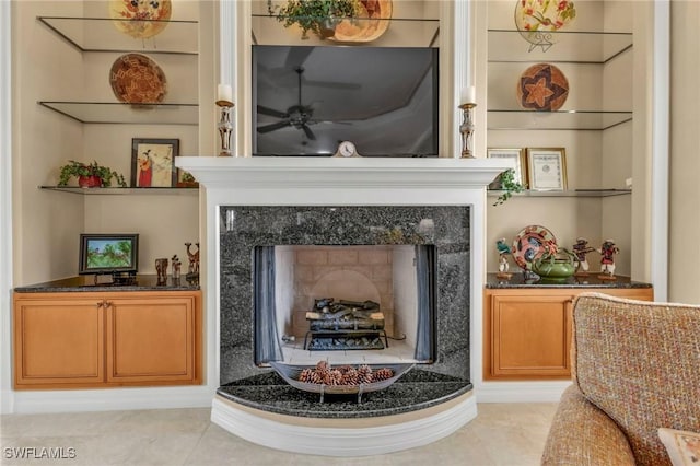 sitting room featuring light tile patterned floors, a high end fireplace, and built in features