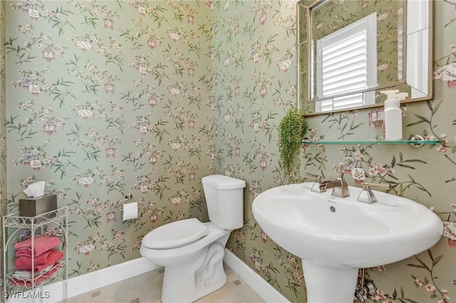 bathroom with sink, tile patterned floors, and toilet