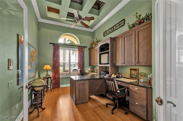 office with coffered ceiling, crown molding, light wood-type flooring, ceiling fan, and beam ceiling