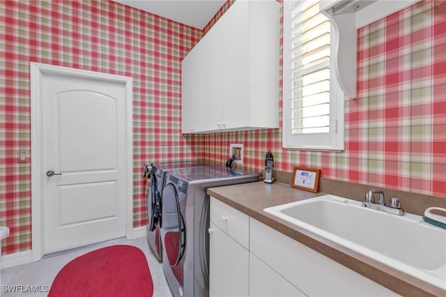 laundry room with sink, cabinets, and washing machine and clothes dryer