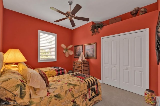 carpeted bedroom featuring ceiling fan and a closet