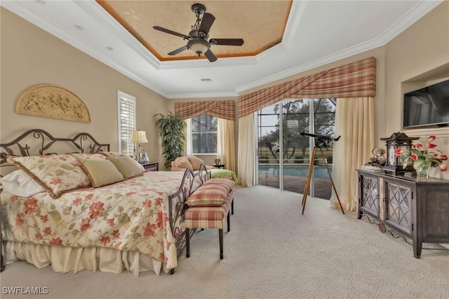 carpeted bedroom with crown molding, ceiling fan, access to exterior, and a raised ceiling