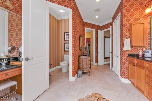 bathroom featuring vanity, tile patterned flooring, crown molding, and toilet