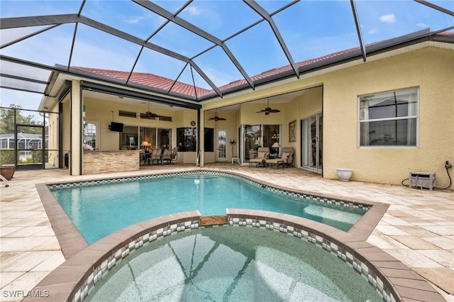 view of swimming pool with an in ground hot tub, a lanai, ceiling fan, and a patio area