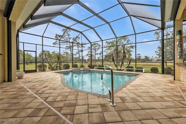 view of pool with a patio area, an in ground hot tub, and glass enclosure