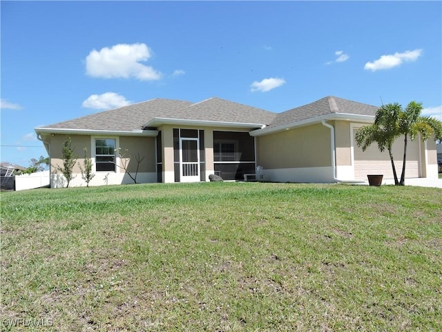 view of front facade with a sunroom and a front yard