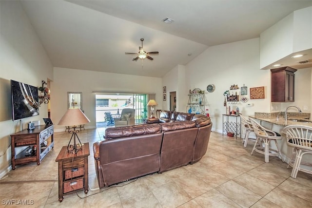 tiled living room with sink, high vaulted ceiling, and ceiling fan