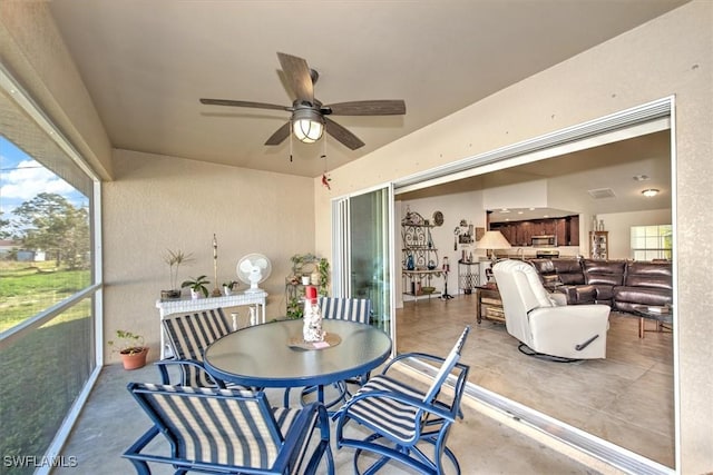 interior space with a wealth of natural light and ceiling fan