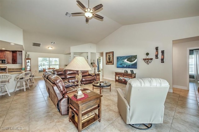 living room featuring high vaulted ceiling, a wealth of natural light, ceiling fan, and light tile patterned floors