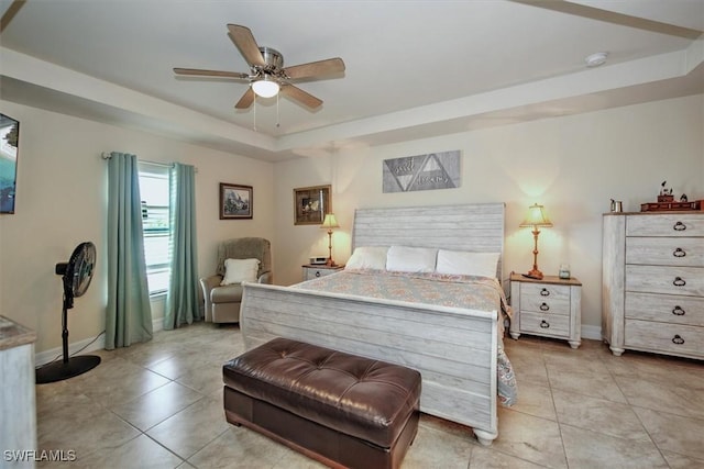 bedroom featuring light tile patterned floors and a tray ceiling