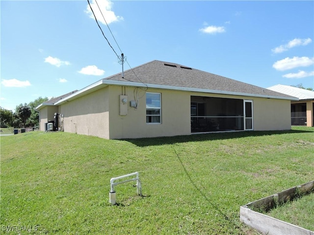 rear view of house featuring a yard