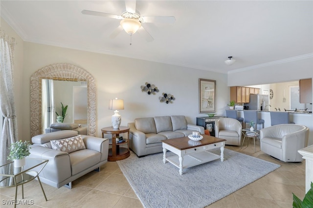 living room featuring light tile patterned floors, ornamental molding, and ceiling fan