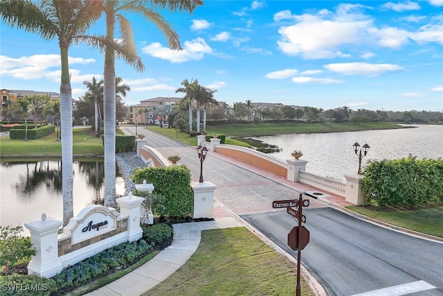 view of property's community with a water view and aphalt driveway