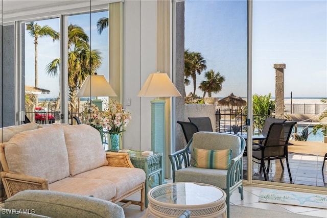 living area featuring a water view and a wealth of natural light