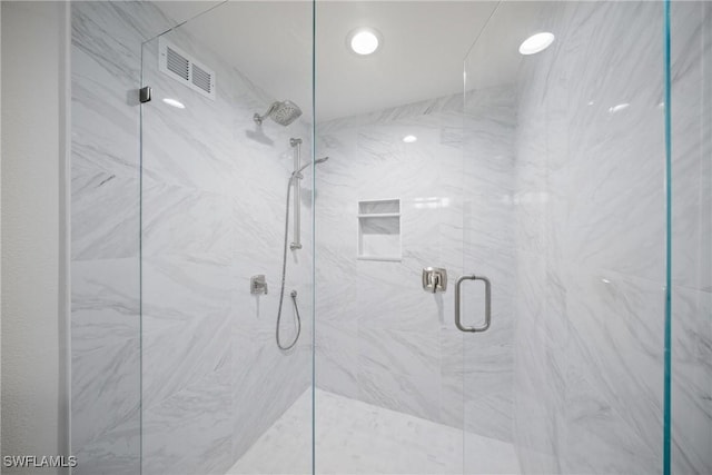 bathroom with a shower with shower door