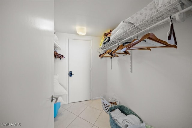 spacious closet featuring light tile patterned flooring