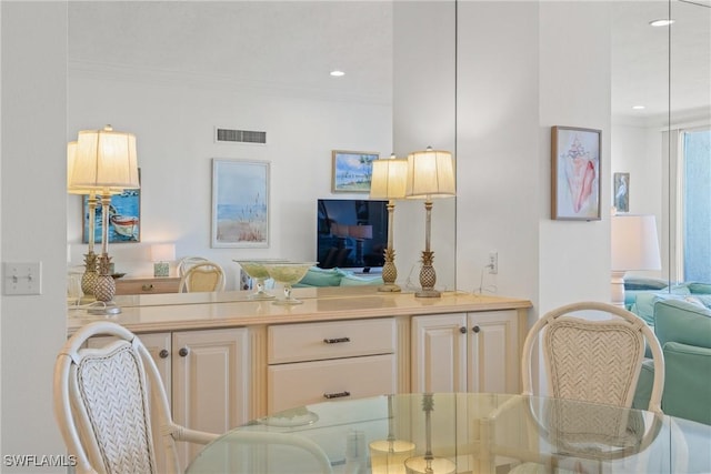 interior space with ornamental molding, recessed lighting, and visible vents