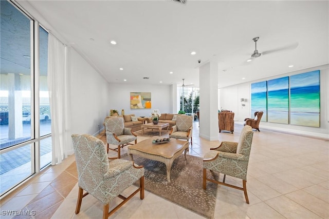 living room with baseboards, a wall of windows, light tile patterned flooring, and recessed lighting