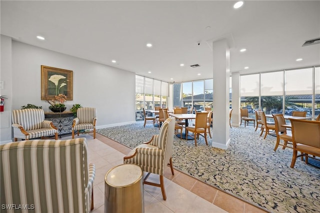 tiled living room featuring floor to ceiling windows