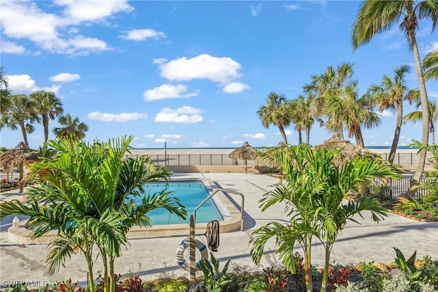 community pool featuring a patio area and a fenced backyard