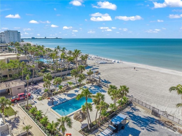 aerial view with a water view and a beach view