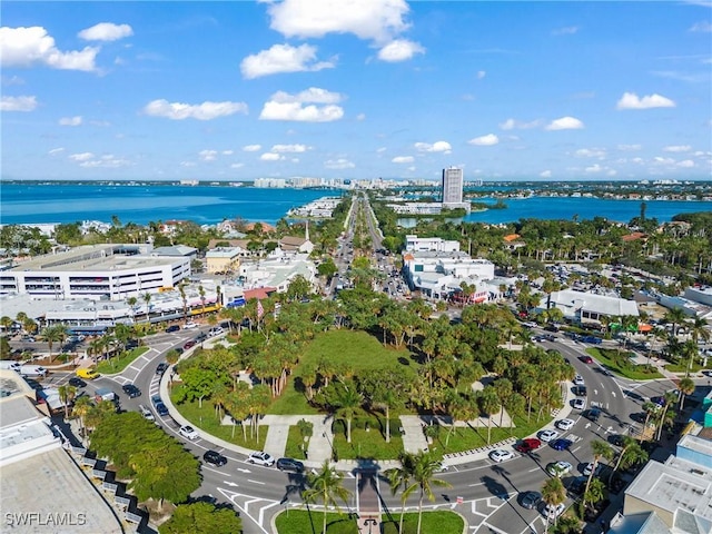 birds eye view of property with a view of city and a water view