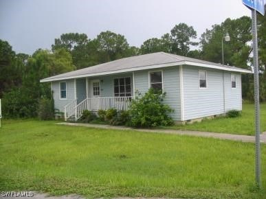 ranch-style home with a porch, a front yard, and crawl space