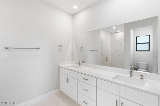 bathroom with toilet, vanity, and walk in shower