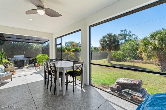 sunroom featuring ceiling fan