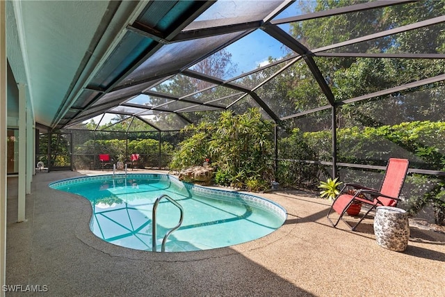 view of swimming pool featuring a lanai and a patio