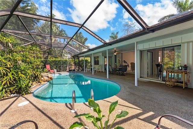 view of pool featuring a patio, ceiling fan, and glass enclosure