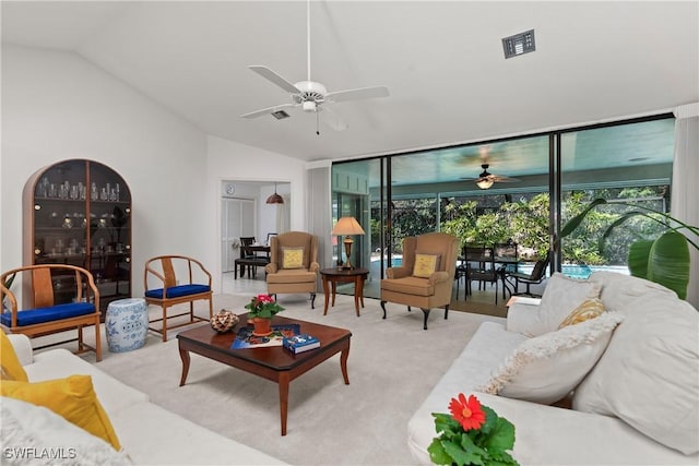 carpeted living room featuring ceiling fan, lofted ceiling, a wealth of natural light, and a wall of windows