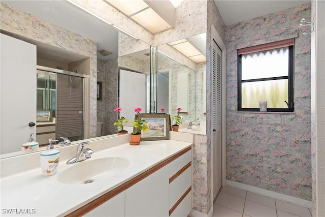 bathroom featuring tile patterned flooring and vanity