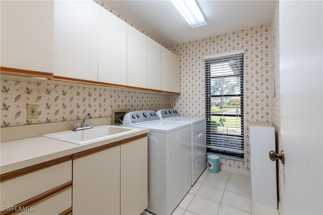 clothes washing area featuring sink, light tile patterned floors, cabinets, and independent washer and dryer