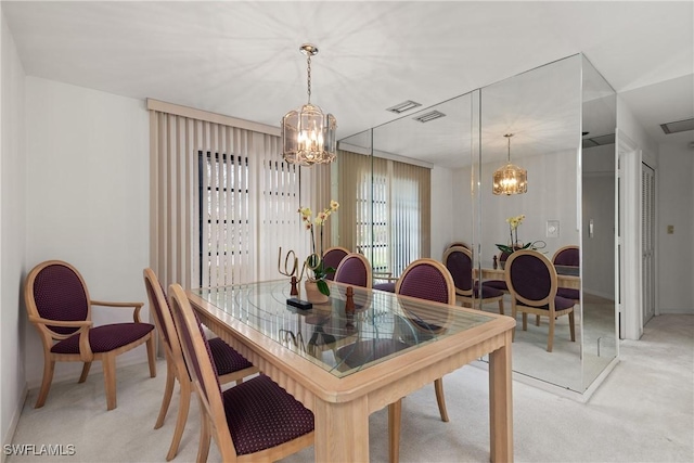 dining area featuring a notable chandelier and light colored carpet