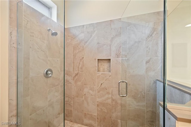 bathroom featuring a shower with door