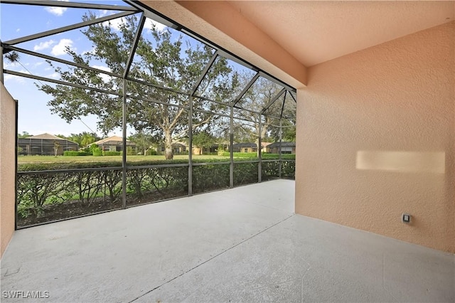 view of patio with glass enclosure