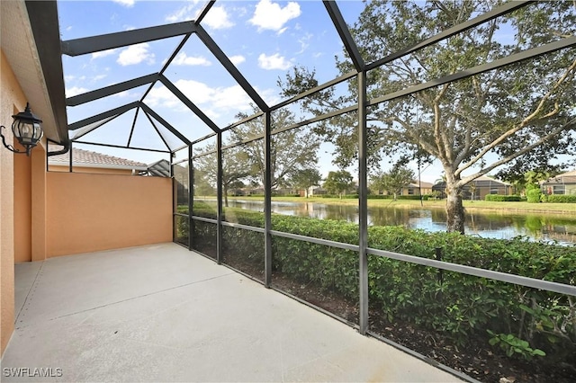 view of patio / terrace with a water view and a lanai