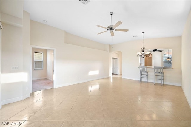 unfurnished living room featuring light tile patterned flooring and ceiling fan with notable chandelier