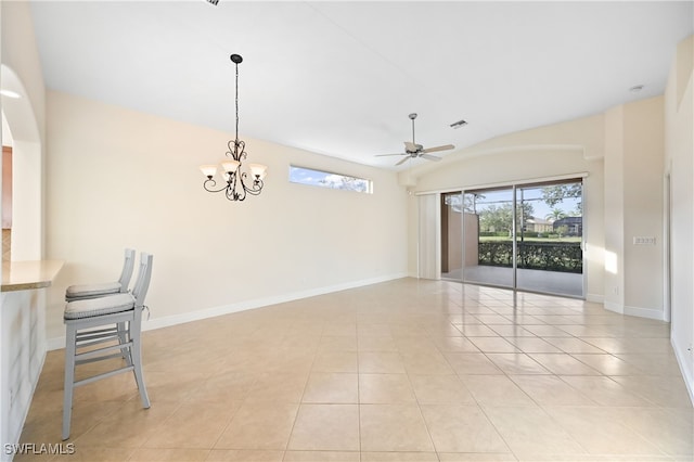 spare room with light tile patterned flooring, plenty of natural light, ceiling fan with notable chandelier, and lofted ceiling